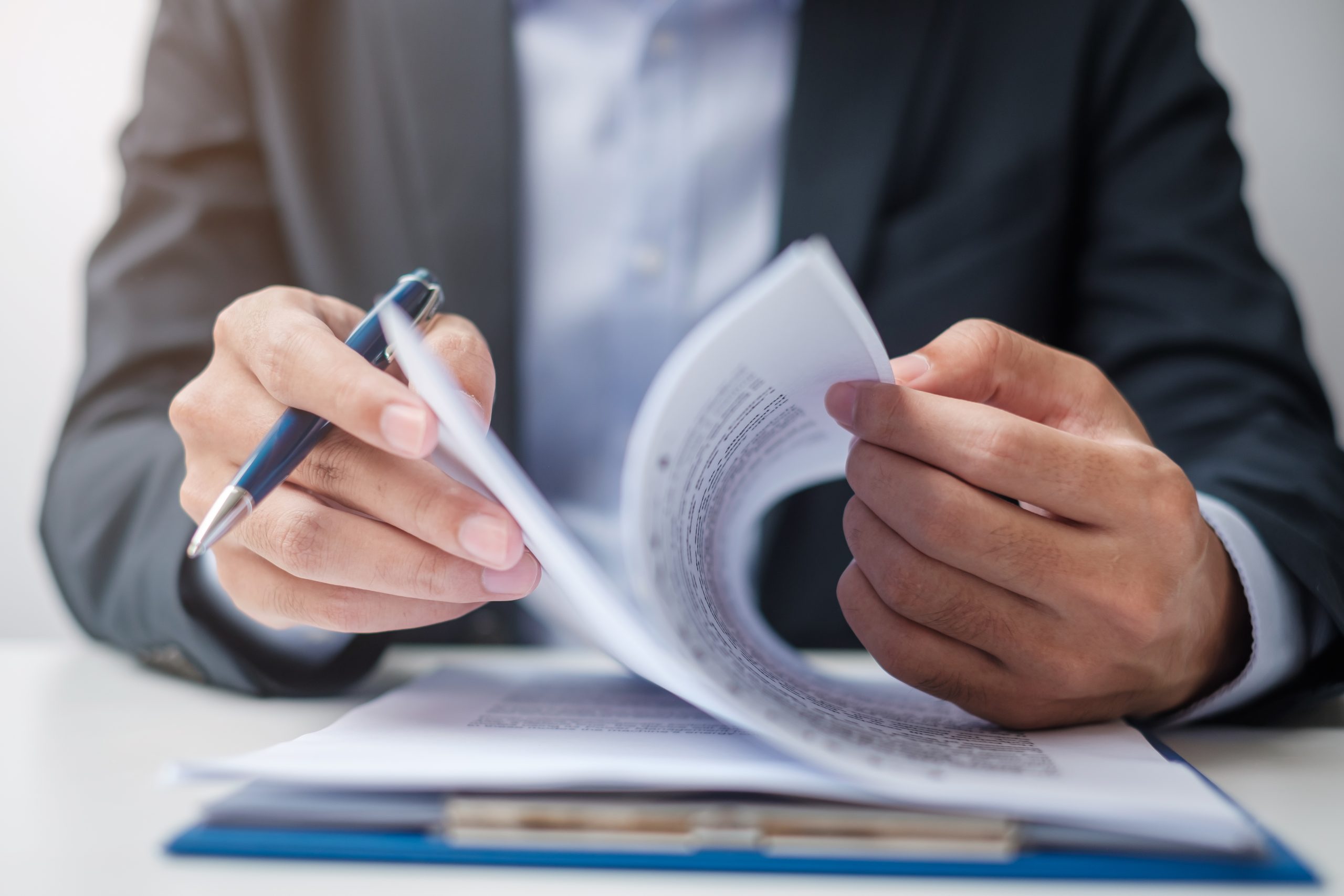Business professional signing contract documents — contract-to-hire recruitment at Sovereign Tech