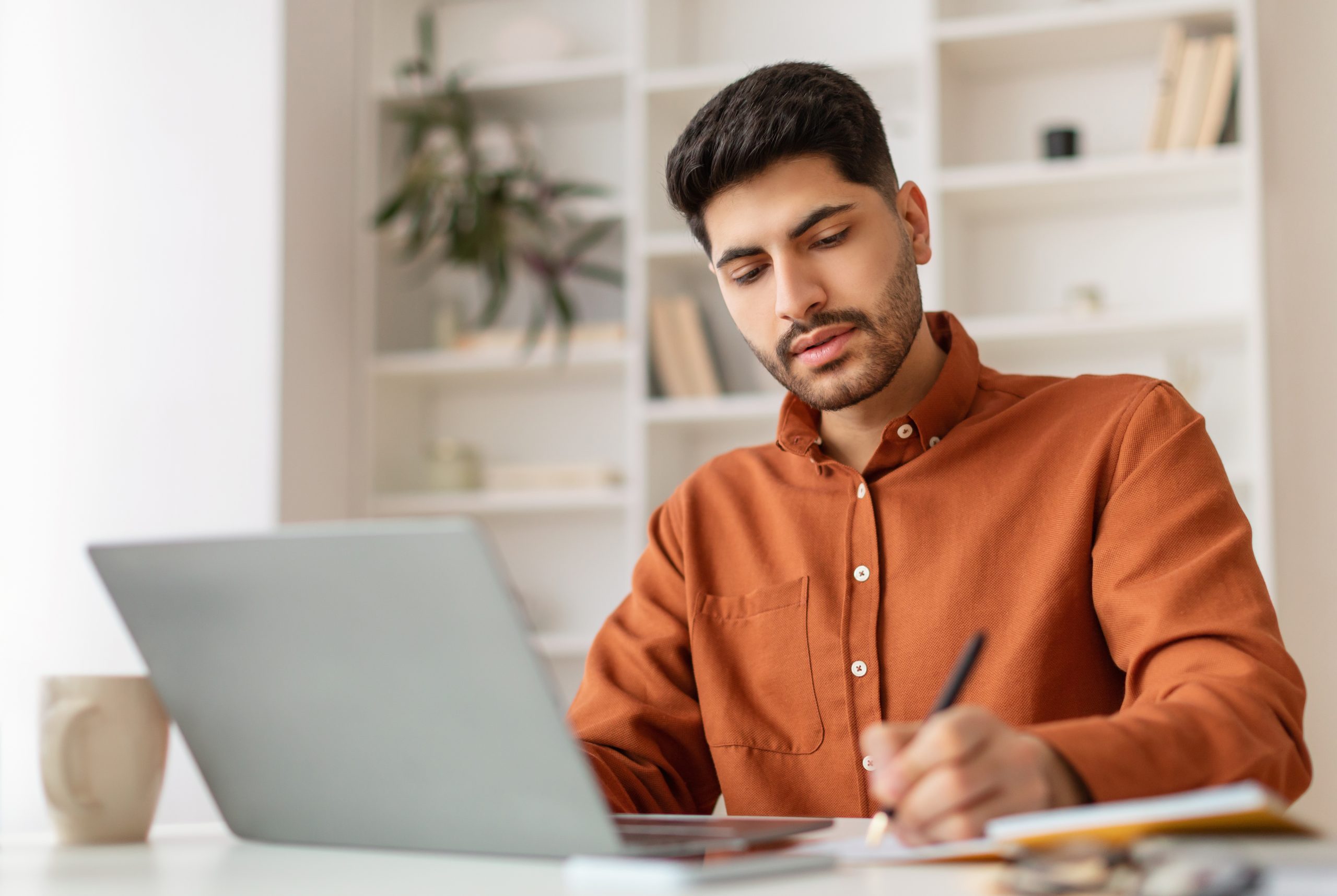 DevOps recruiter focused on laptop at modern workspace — Sovereign Tech Recruitment